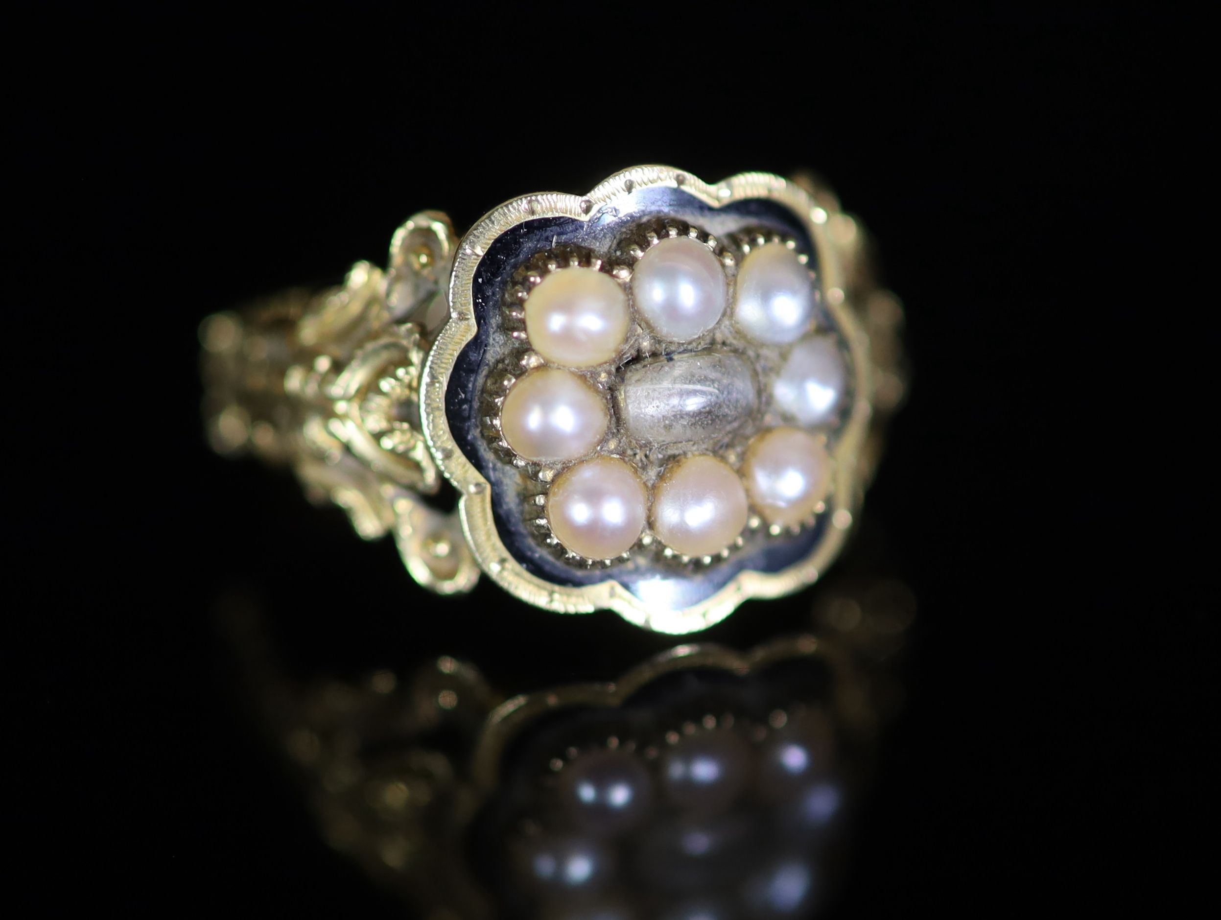 A William IV 18ct gold, black enamel and seed pearl set mourning ring